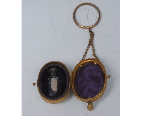 A 19th century French gilt metal and mother of pearl egg shaped scent bottle case, enclosing a miniature phial, suspension ch