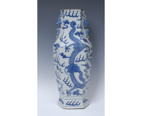 A Chinese hexagonal vase, painted in underglaze blue with dragons chasing the flaming pearl, temple lion handles to shoulders