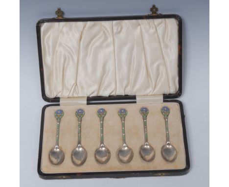 A set of six George V silver and enamel coffee spoons, each terminal decorated with stylised flowers in tones of blue, green 