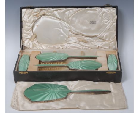 An Art Deco silver and enamel five piece dressing table set, comprising a hand mirror, a pair of hair brushes and a pair of c