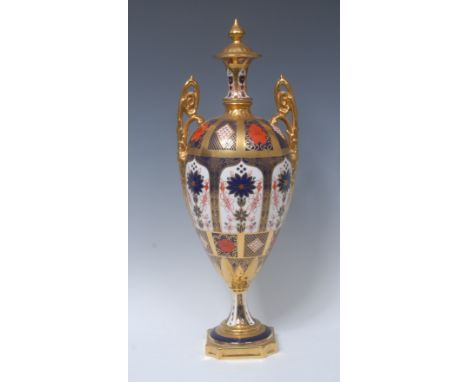 A Royal Crown Derby 1128 pattern pedestal ovoid vase and cover, spire finial, elaborate scroll handle, spreading circular bas