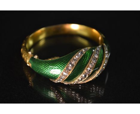  A fine 19th century diamond and emerald green guilloche enamel hinged bangle, the graduated stones on three wrythen bands on