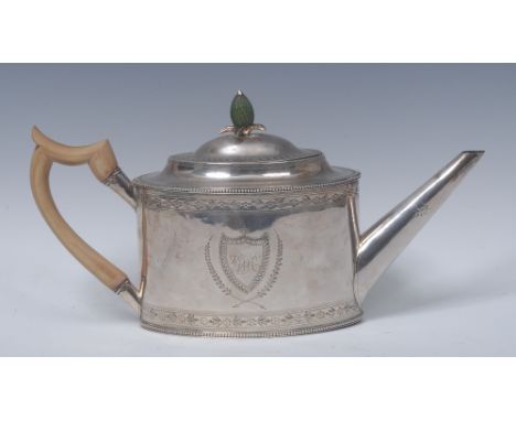 A George III silver drum shaped teapot, stained ivory pinecone finial, flush-hinged domed cover, bright-cut engraved with shi