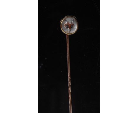 An 18ct gold mounted rock crystal stick pin, the domed cabachon intaglio carved and painted with a fox, 7cm long 