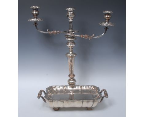 A large Sheffield plated three-light, two branch candelabrum, with detachable floral nozzles, campana shaped sconces, taperin