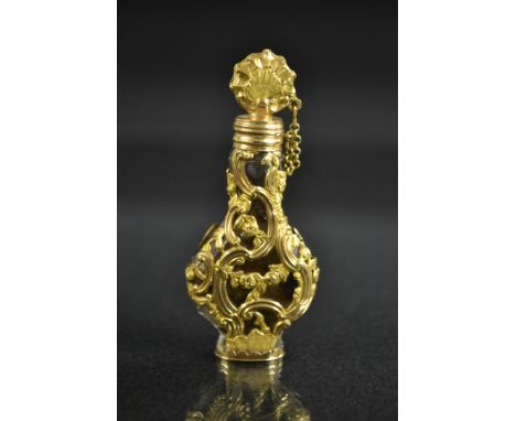 A 19th century  French rococo facet cut gold mounted pear shaped scent flask, the whole encased with flowering stems, C-scrol