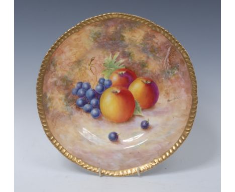 A Royal Worcester circular plate, painted by Frank Higgins, signed with ripe apples and grapes on a mossy ground, gadrooned r