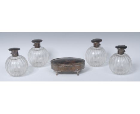 A set of four George V scent bottles, clear glass globular bodies engraved with vertical lines, hinged silver and tortoiseshe