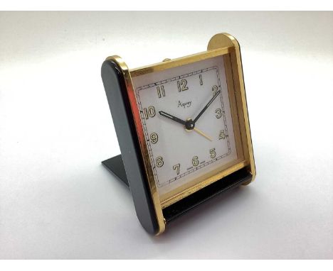 Asprey; An Art Deco Style Travel Alarm Clock, in black and brass, case back stamped "2060 Swiss", 8.3cm high.The clock is cur