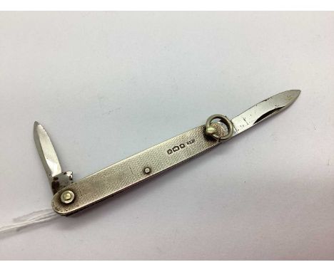 A Hallmarked Silver Folding Pocketknife, Cohen &amp; Charles, London 1954, of allover engine turned design with vacant lozeng