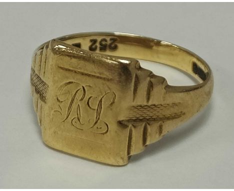 A 9ct Gold Signet Ring, the rectangular panel initialled "RL", between tapered shoulders of stepped design with engine turned