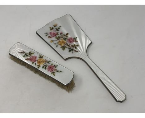 A two piece floral enamel and silver mirror and brush set 