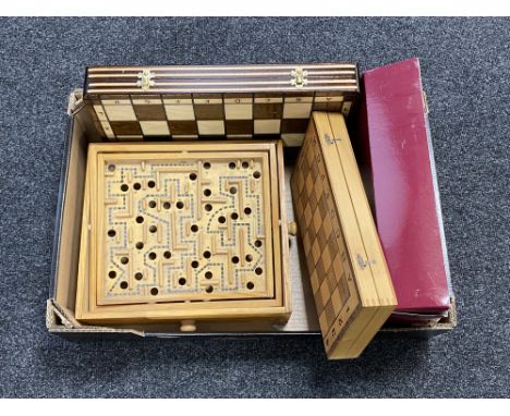 A box of boxed Bagatelle board, two wooden chess boards, wooden ball maze 