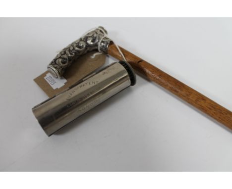 A silver handled walking cane and a vintage pocket cigar roller 