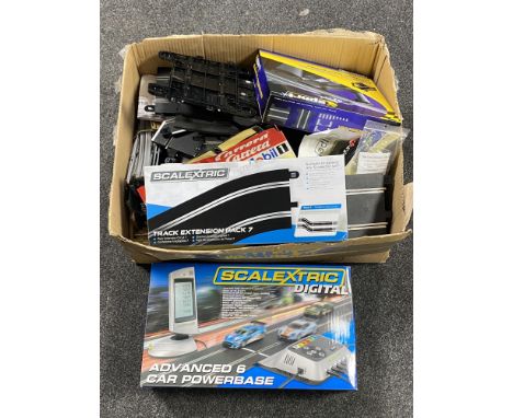 A boxed Scalextric digital advanced 6 car power base together with a further box of track and stickers 