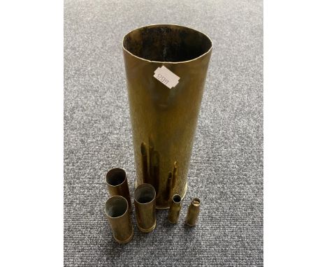 Six brass ammunition casings 