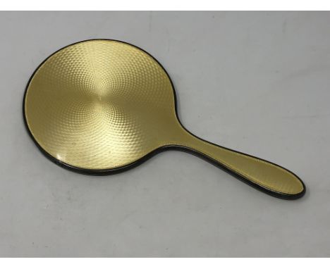 A silver and yellow guilloche enamel hand mirror, Birmingham marks 