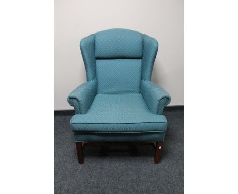 A Carolina Sofa Factory wingback armchair in turquoise fabric 