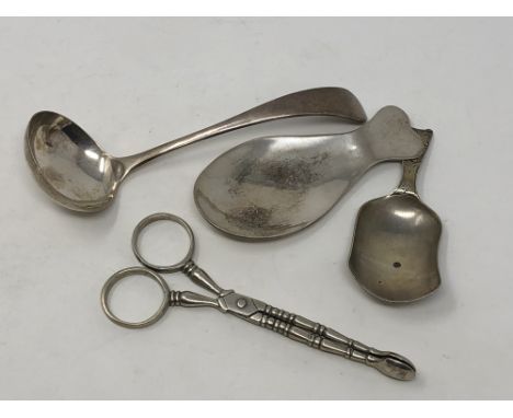 A silver ladle, two caddy spoons, tongs