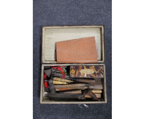 A vintage leather luggage case containing  a quantity of joinery tools 
