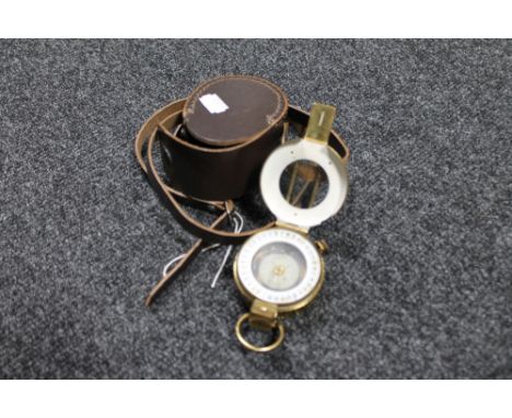 A brass cased nautical compass in leather pouch 