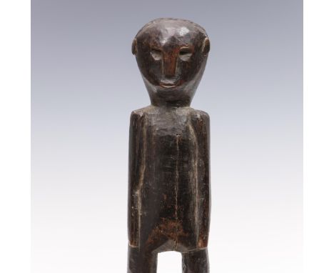 Indonesia, Timor or Sumba, a standing anthropomorphic figure, with feet carved backwards and black brown glossy patina.  h. 3