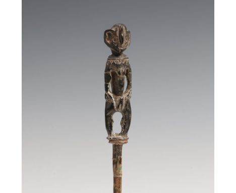 P.N. Guina, Humboldt Bay - Sentani Lake, a wooden lick stick surmounted by a standing female anthropomorphic figure. Decorate