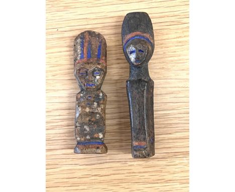 Mbole, two small wooden amulet figures with remnants of red- and blue pigments.