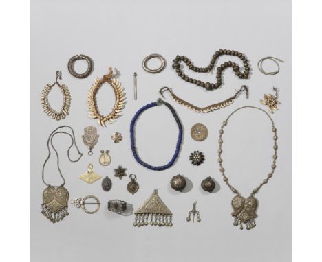 A collection of various silvered and metal ornaments. Herewith a four Melanesian ornaments and a glass beaded string and Java