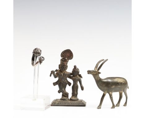 A bronze antique sculpture of a deer, a bronze India figure group and a silver alloy ring in the shape of a lion's head. Deer