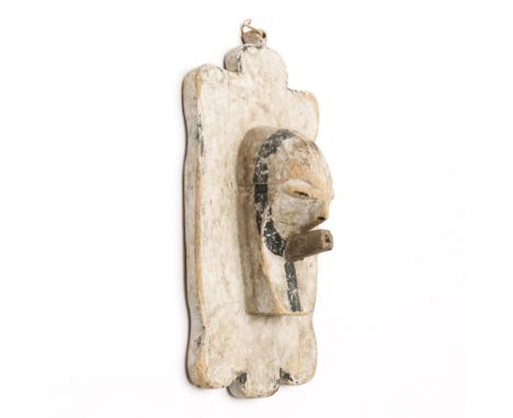 D. R. Congo, Songye-Luba, plank mask, with a kifwebe mask in high relief on a shield like plank. details in black on a white 