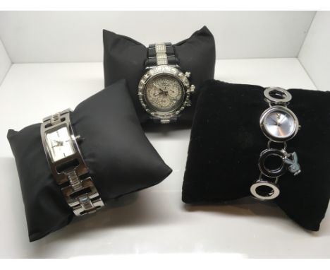 A ladies DKNY watch, a Playboy watch and a Toy Chronograph watch, all in working order and complete with a box. (3) Postage t