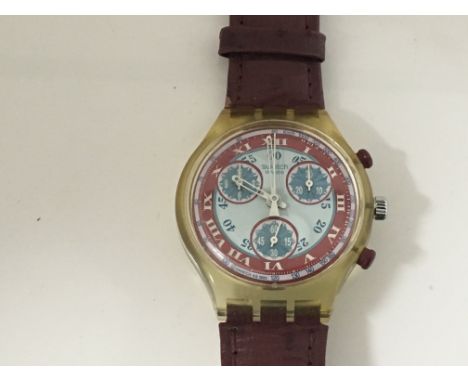 A designer Swatch Watch Claret and blue dial plastic case, visible mechanism. The dial has three subsidiary dials in working 