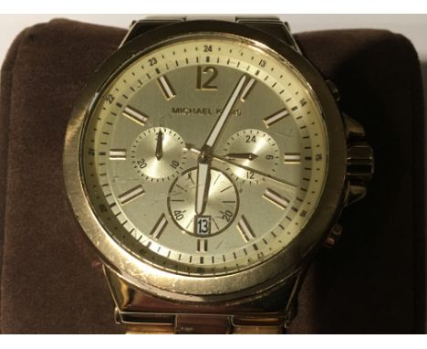 A Gents Michael Kors Chronograph watch with date feature, in a gold colour stainless steel case and bracelet, MK-8278 comes c