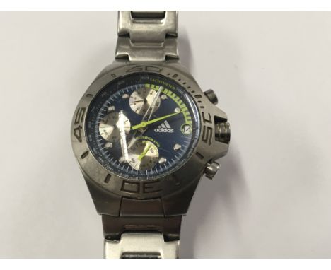 A Gents Chronograph Quartz Adidas Watch. Blue dial illuminated green second hand in working order. Postage to the U.K. is £15