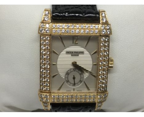 An Patek Philippe Gentlemans dress watch, The solid 18ct gold cased set with high grade brilliant cut diamonds in two rows an