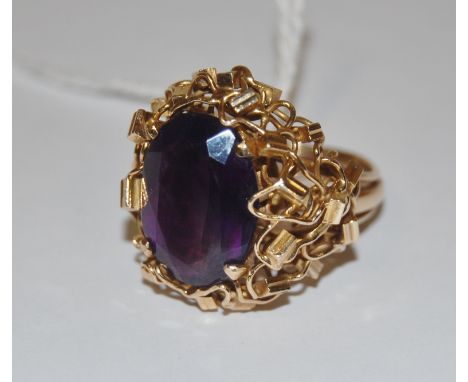 A ladies 9ct gold studio jewellery amethyst set ring, the large oval cut amethyst measuring 18 x 13mm, in a bespoke wove and 