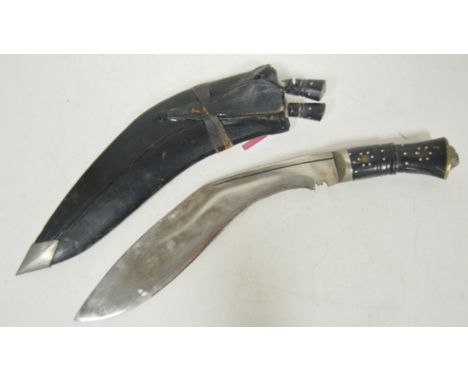 An Indian kukri in leather scabbard