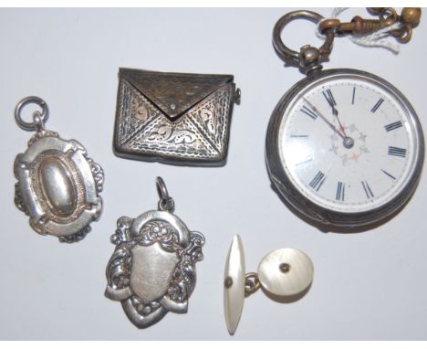 An American silver cased ladies open faced pocket watch, a silver stamp cased pendant, and two other silver pendants (4)