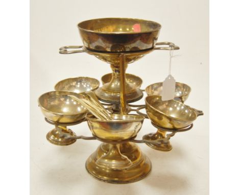 A silver plated dessert table centrepiece having central bowl with 6 outer bowls and matching spoons