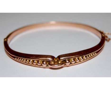 A 9ct gold ladies hinged bangle, 6.3g