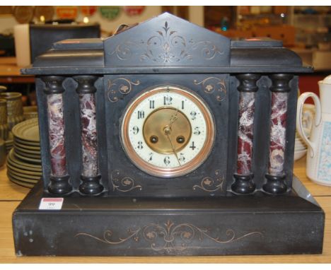 A circa 1900 slate mantel clock of architectural form having enamel dial with Arabic numerals