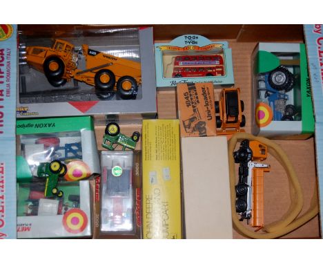 Box of assorted toy vehicles to include John Deere tractor and dump cart together with a box of various  magazines of truckin