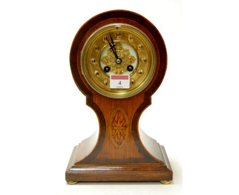 An Edwardian oak cased rosewood cross banded and satinwood inlaid balloon shaped mantel clock having a brass chapter ring wit