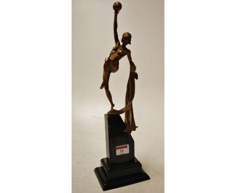 An Art Deco style resin figure of a dancer on a stepped plinth base