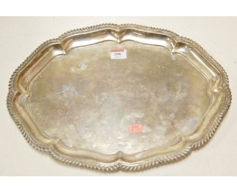 A silver salver of shaped oval form having gadrooned piecrust rim, 27.2oz, marks worn, diameter 40.5cm