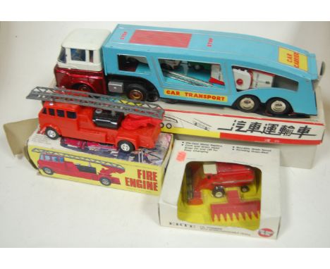 A Chinese tinplate car transporter No. MF868, boxed, together with an Ertl combine, and a Hong Kong issue fire engine (3) Con