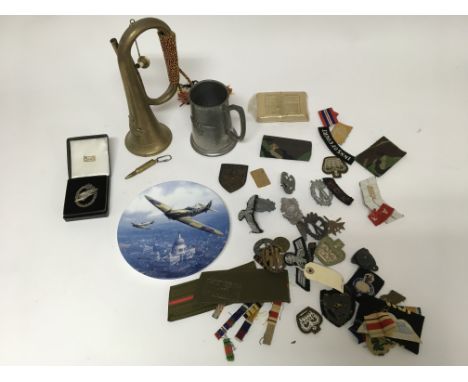 A group of military badges and patches, including some oddments such as a tankard, a bugle and plate. Largely German WW2 item