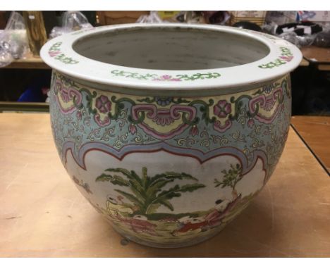 An Oriental ceramic fish bowl decorated with figures to the exterior.