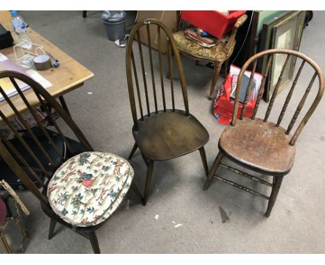 A group of three wooden chairs to include a pair of Ercol chairs.